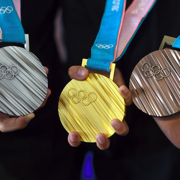 De geschiedenis van goud, zilver en brons bij prijsuitreikingen